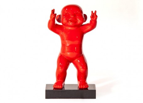Statue of a red baby man in resin